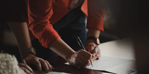 People signing documents